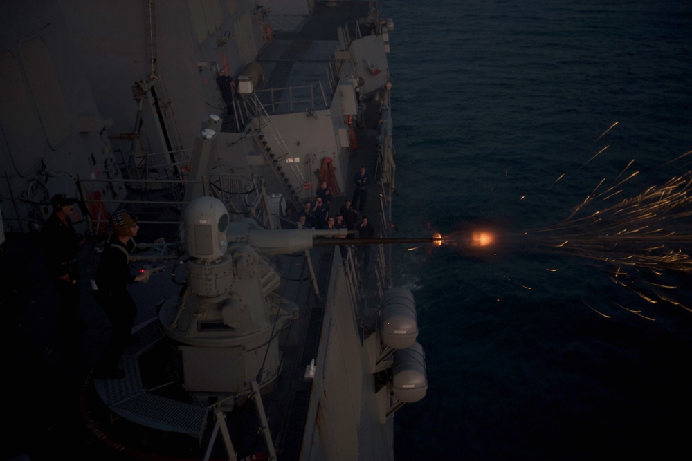 A Mark 38 25mm machine gun system fires aboard USS Chung-Hoon