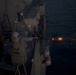 A Mark 38 25mm machine gun system fires aboard USS Chung-Hoon