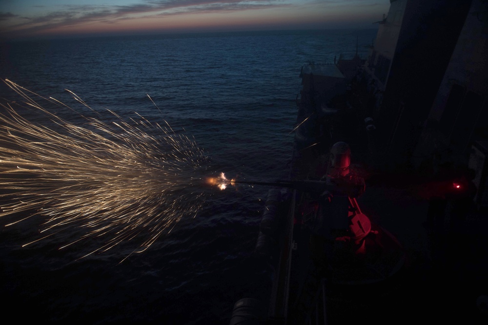 A Mark 38 25mm machine gun system is fired aboard USS Chung-Hoon