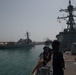 U.S. Sailors man the rails aboard the guided-missile destroyer USS Chung-Hoon (DDG 93) while entering Manama, Bahrain