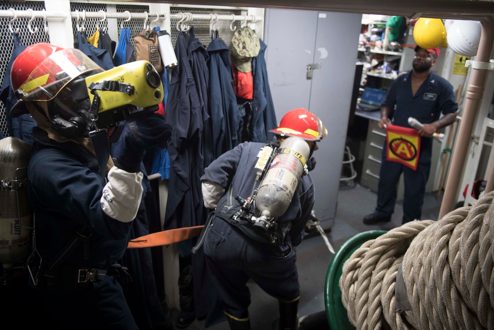 U.S. Navy Sailors engage simulated casualties during a general quarters drill aboard the USS Spruance.