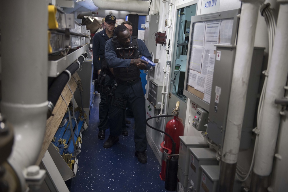 Sailors maneuver through their ship while responding to a simulated active shooter