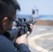 Quartermaster 3rd Class Vhlake Abangan, from Temecula, California, fires an M4 carbine rifle during a small arms weapons qualification aboard the USS Spruance (DDG 111).