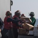 U.S. Sailors unload pallets during a replenishment-at-sea