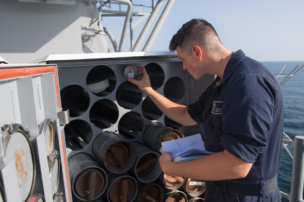 U.S. Navy Cryptologic Technician (Technical) checks a chaff magazine temperature