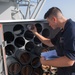 U.S. Navy Cryptologic Technician (Technical) checks a chaff magazine temperature