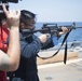 Quartermaster 3rd Class Vhlake Abangan, from Temecula, California, fires an M4 carbine rifle during a small arms weapons qualification aboard the USS Spruance (DDG 111).