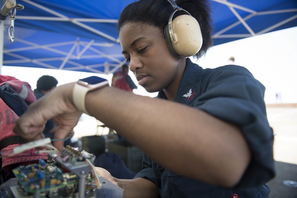 Interior Communications Specialist 2nd Class Ashanti Gilchrist, from Los Angeles, repairs a vital interior communications network aboard the guided-missile destroyer USS Spruance (DDG 111).