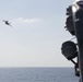 An F/A-18 Super Hornet, from the aircraft carrier USS John C. Stennis (CVN 74), flies by the guided-missile destroyer USS Spruance