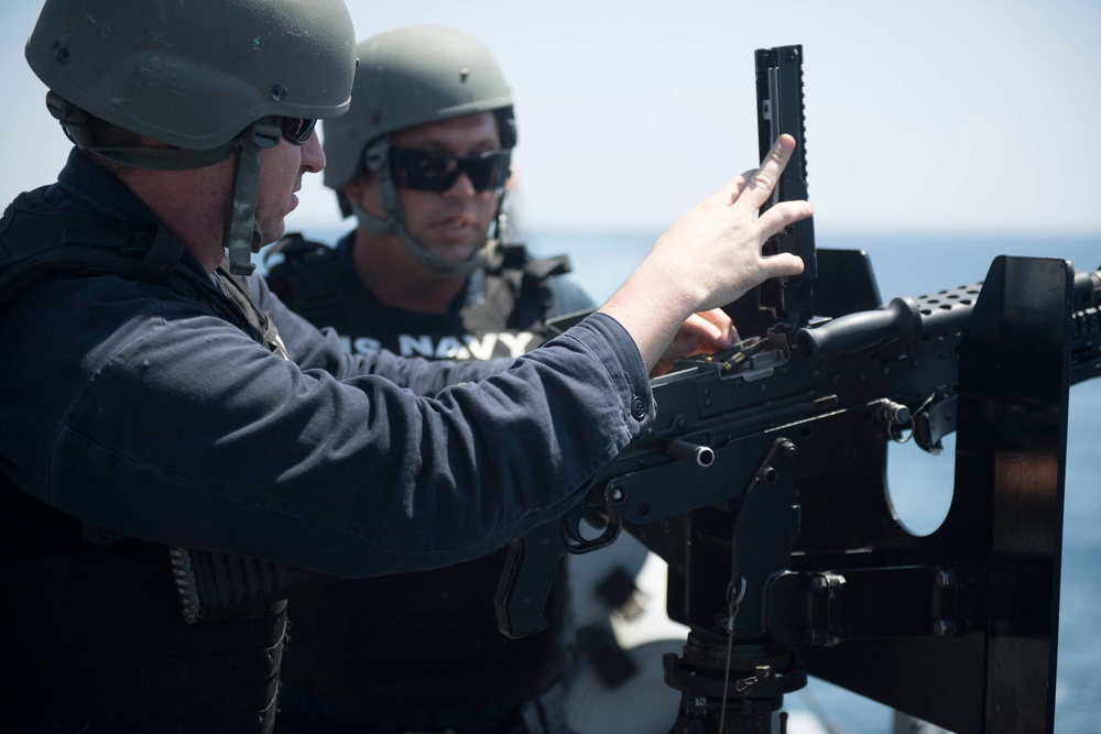 U.S. Navy Sailors participate in a crew served weapons qualification aboard the guided-missile destroyer USS Spruance (DDG 111).