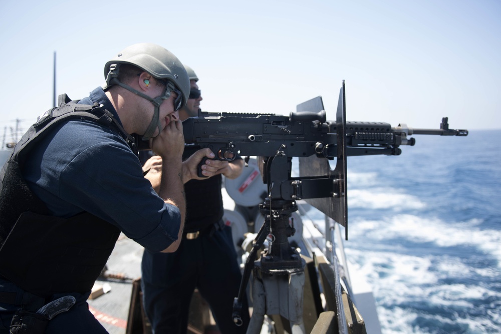 U.S. Navy Sailors participate in a crew served weapons qualification aboard the guided-missile destroyer USS Spruance (DDG 111).