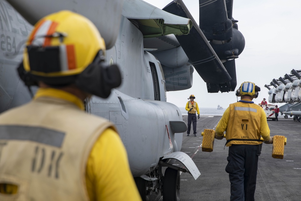 Sailors move an MV-22 Osprey