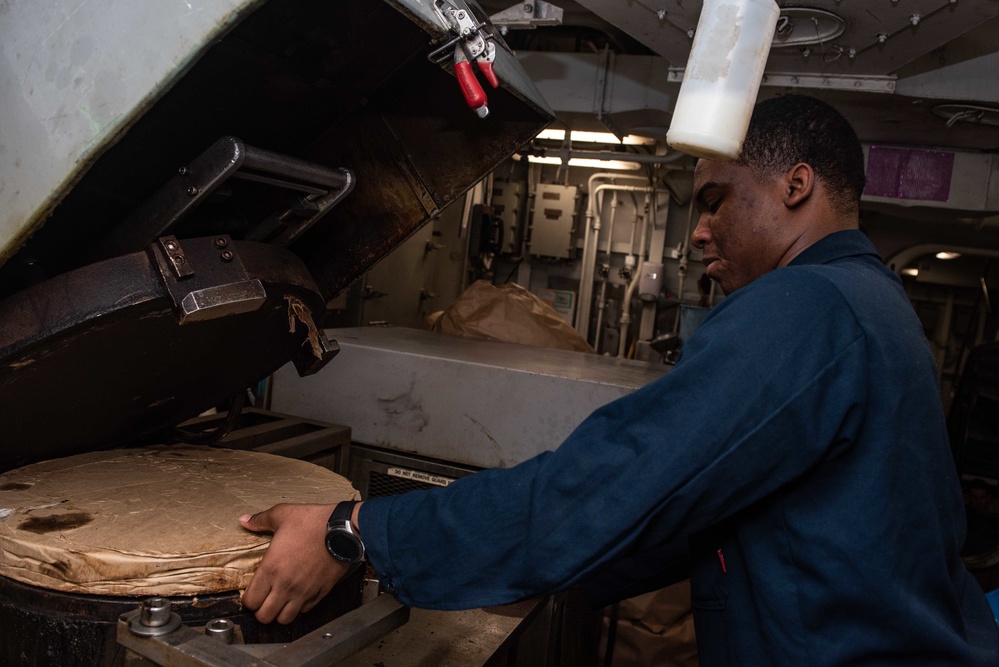 U.S. Sailor processes waste material