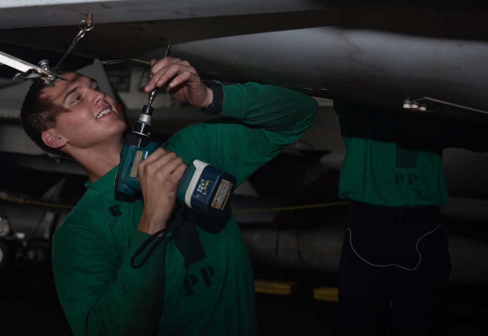 U.S. Sailor installs a door