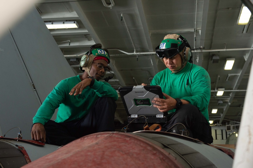 U.S. Sailors conduct maintenance on a quad reciever