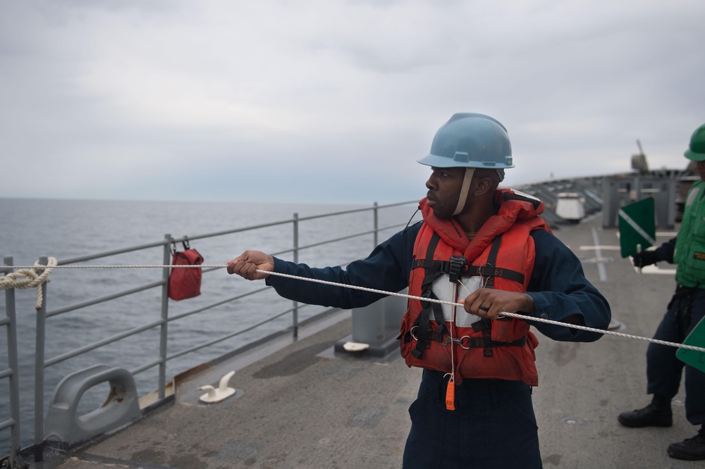 U.S. Navy Counselor handles the phone and distance line aboard the guided-missile cruiser USS Mobile Bay