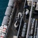 U.S. Sailors load cargo onto the flight deck