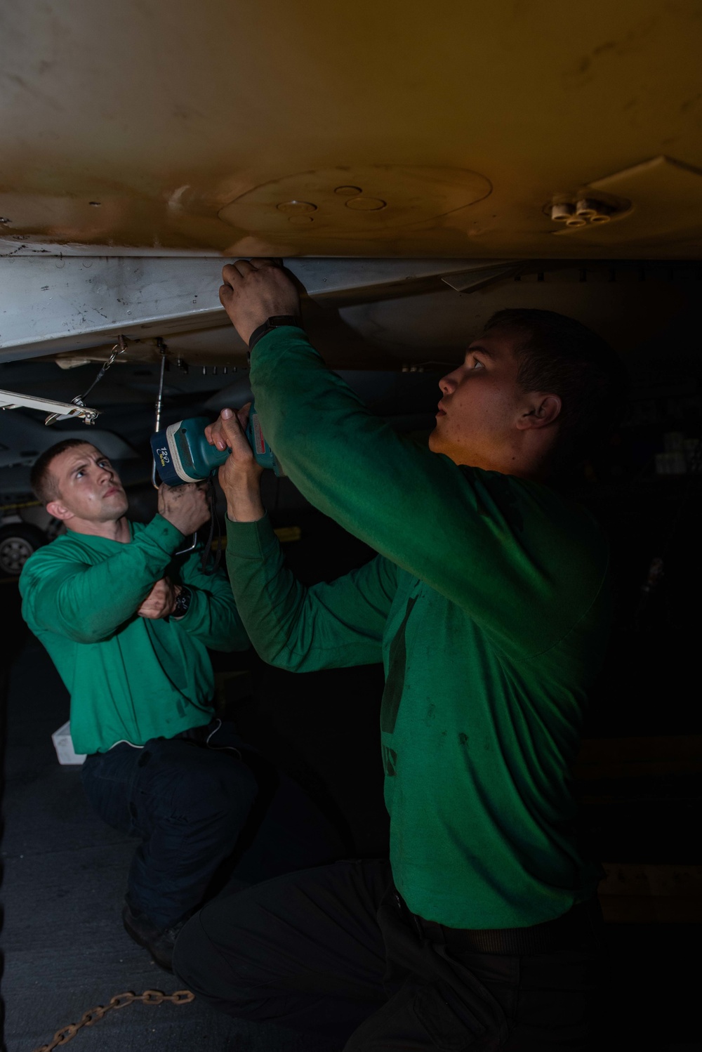 U.S. Sailors install a door