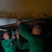 U.S. Sailors install a door