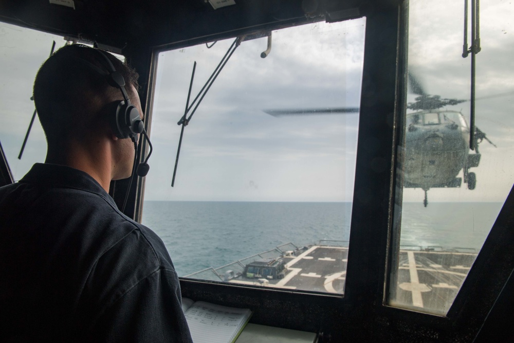 MH-60S Sea Hawk helicopter launches from USS Stockdale