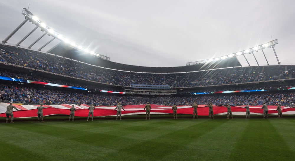 Servicemembers from Whiteman Air Force Base unfurl the American Flag during Kansas City Royals opening game