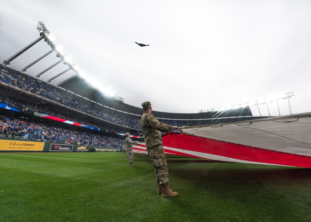 Servicemembers from Whiteman Air Force Base watch B-2 flyover during Kansas City Royals opening game