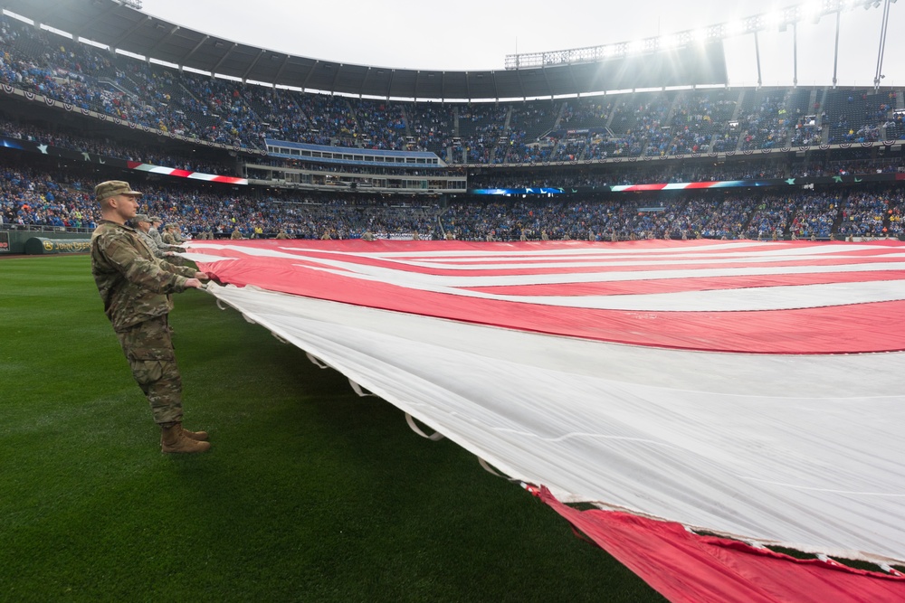 Servicemembers from Whiteman Air Force Base unfurl flag at Kansas City Royals opening game