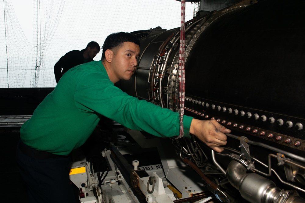 U.S. Sailor installs an engine