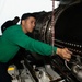 U.S. Sailor installs an engine