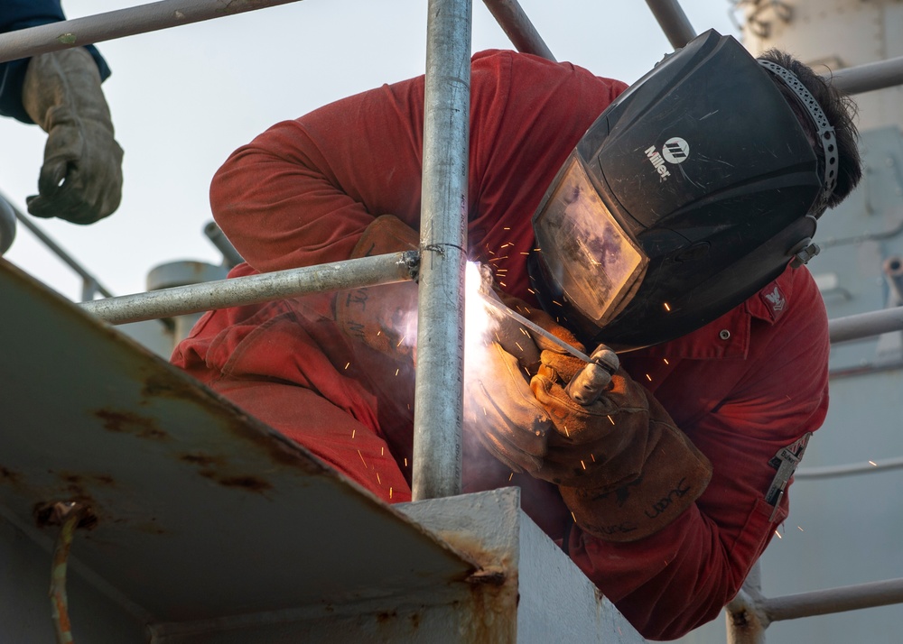 USS Fort McHenry Sailor Welds Railing