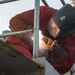 USS Fort McHenry Sailor Welds Railing