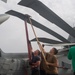 U.S Sailors install support crutches for the rotor wings of an MH-60R Sea Hawk