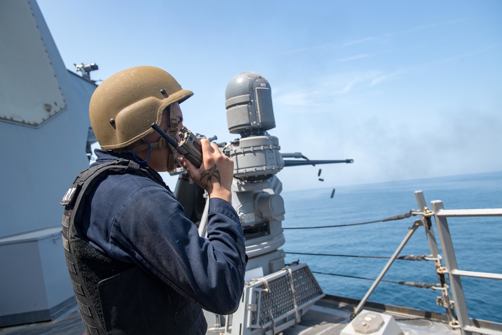 U.S. Sailor talks to the gunnery control officer during a live-fire exercise