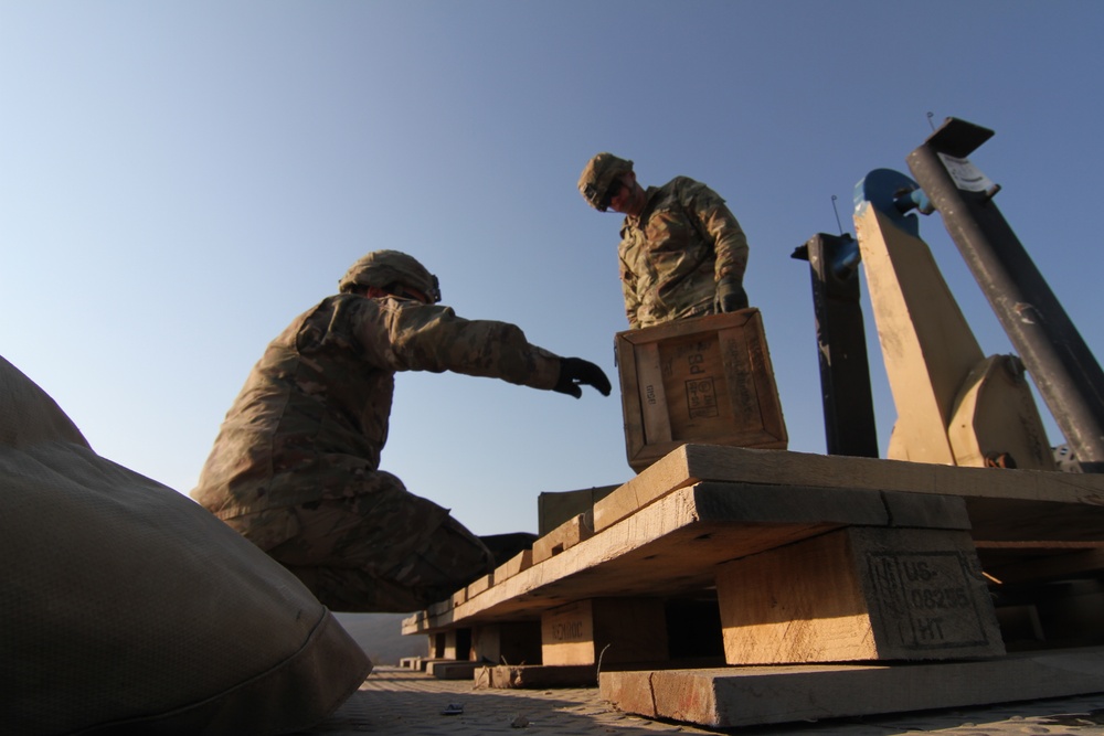 Forward Support Company, 1-16 Infantry Soldiers transport and unload ammunition for live-fire ranges
