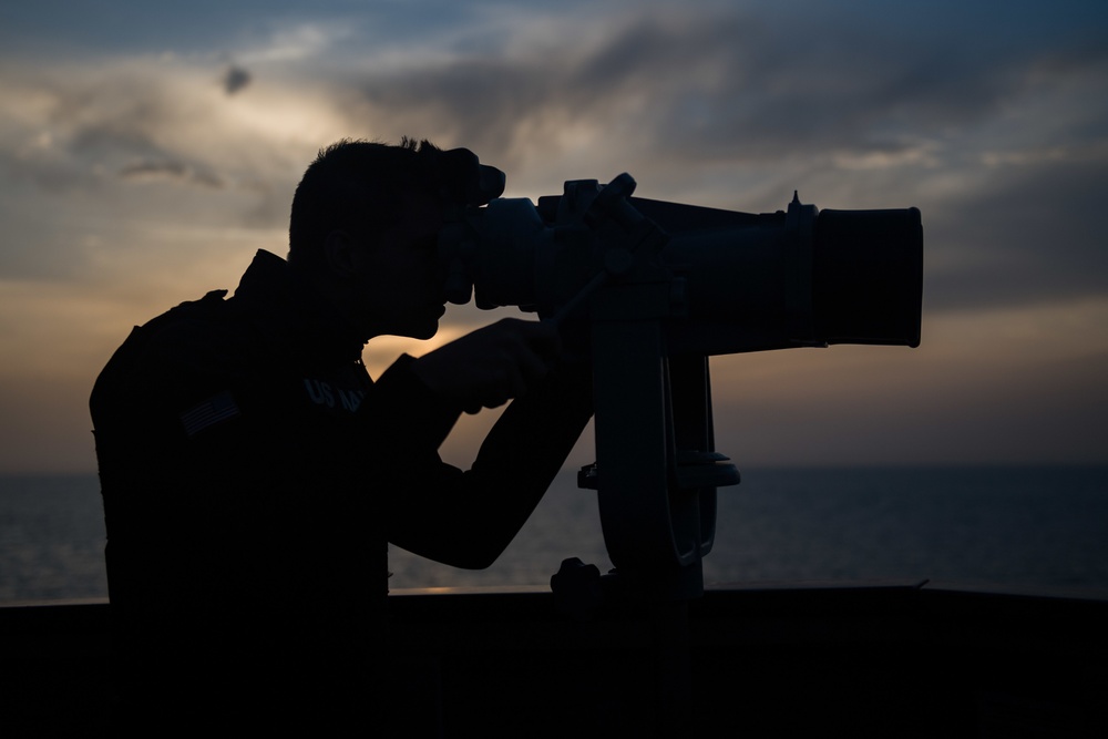 Sailor looks at a contact during a Strait of Hormuz transit aboard USS Stockdale