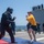 U.S. Navy Ensign attempts to subdue an opponent after being sprayed with oleoresin capsicum spray during security reaction force basic training aboard USS Stockdale