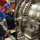 U.S. Sailors conducts maintenance on a jet engine