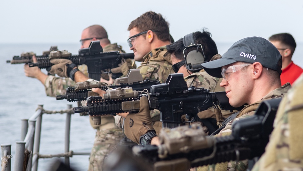 U.S. Sailors fire M4 carbines during a live-fire exercise