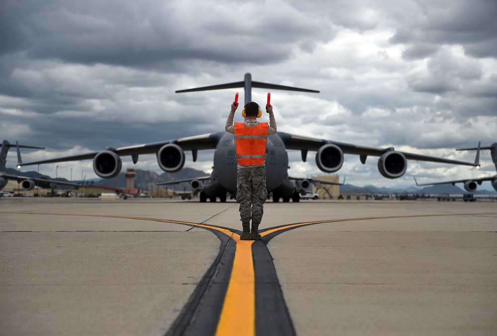 McChord crew chief marshals c-17 on March ARB