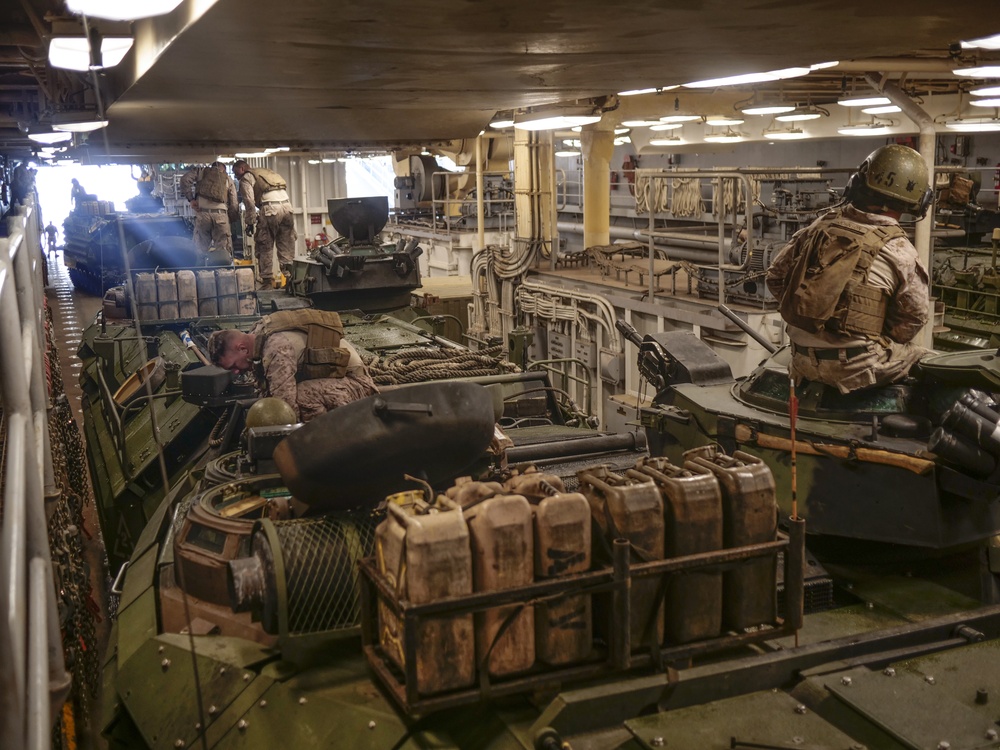 AAVs load into the USS Harpers Ferry