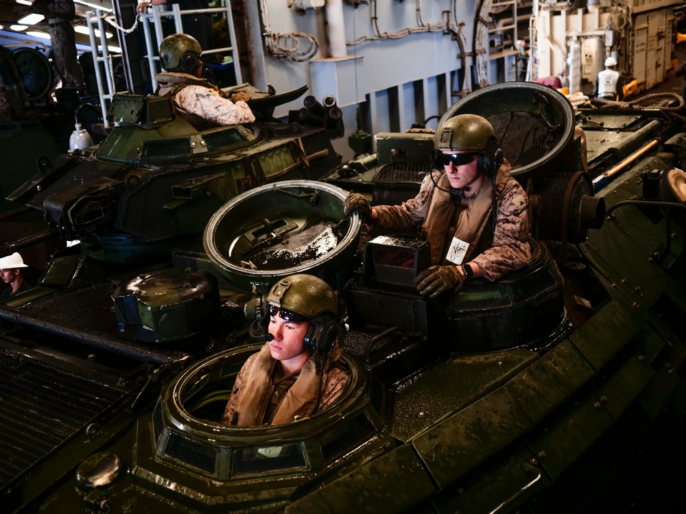 AAVs load into the USS Harpers Ferry