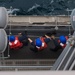 U.S. Sailors pull in a line as USS Mobile Bay conducts a replenishment-at-sea with USNS Alan Shepard in the Arabian Gulf
