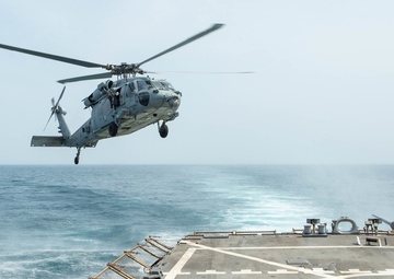 An MH-60S Sea Hawk prepares to land on the flight deck