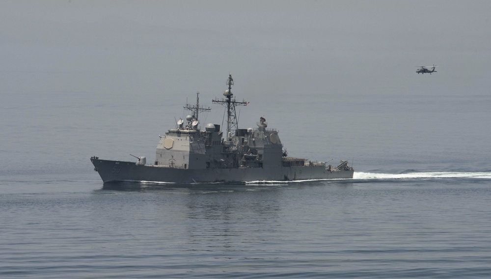 The guided-missile cruiser USS Mobile Bay (CG 53) cuts through the Strait of Hormuz