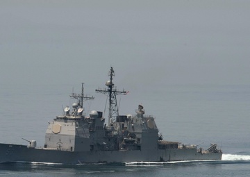 The guided-missile cruiser USS Mobile Bay (CG 53) cuts through the Strait of Hormuz