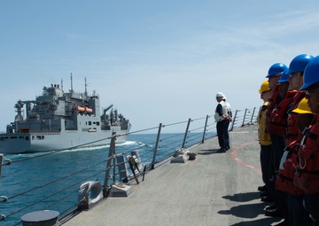 U.S. Sailors observe the dry cargo and ammunition ship USNS Alan Shepard (T-AKE 3) come alongside the guided-missile destroyer USS McFaul (DDG 74)