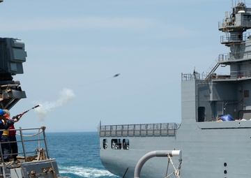 U.S. Sailors fire a shot line from the guided-missile destroyer USS McFaul (DDG 74) to the dry cargo and ammunition ship USNS Alan Shepard (T-AKE 3)