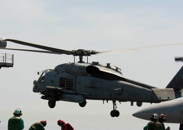 An MH-60R Sea Hawk lands on the flight deck of the aircraft carrier USS John C. Stennis (CVN) in the Strait of Hormuz