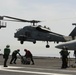 An MH-60R Sea Hawk lands on the flight deck of the aircraft carrier USS John C. Stennis (CVN) in the Strait of Hormuz