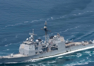 The guided-missile cruiser USS Mobile Bay (CG 53) cuts through the Strait of Hormuz